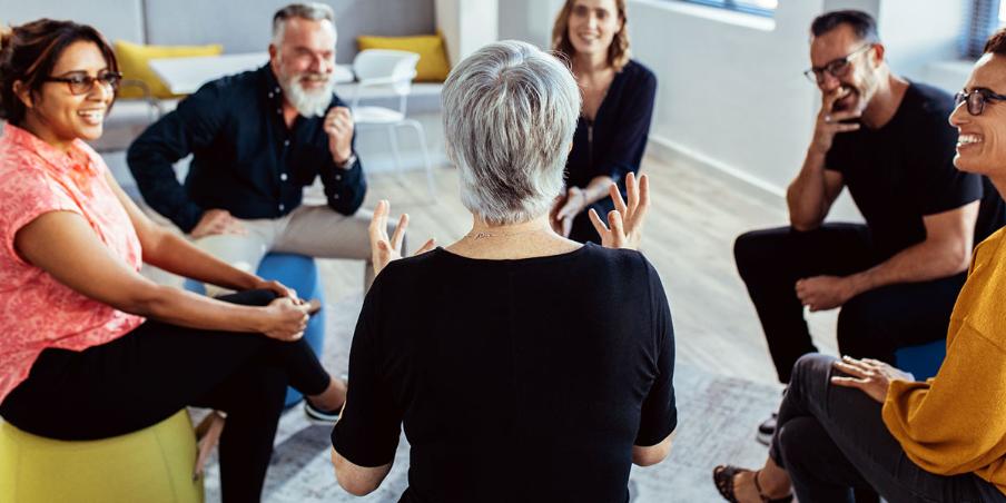 A group of people discussing in a circle