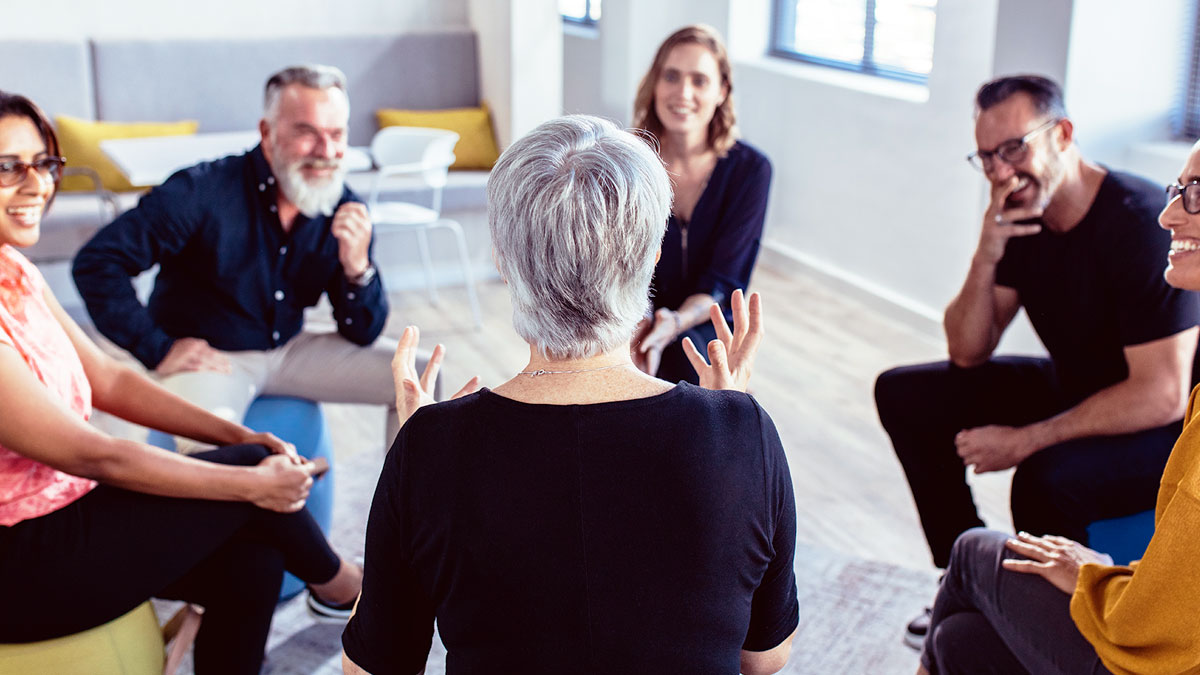 A group of people discussing in a circle