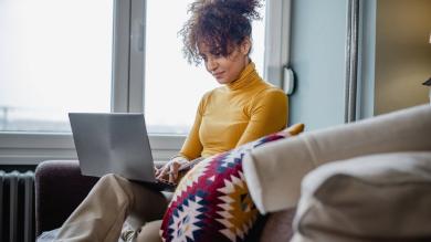 
		A woman is taking part in a training session on her laptop
	