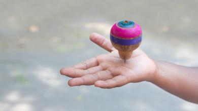 
		Toy spinning top turns on children's hands
	