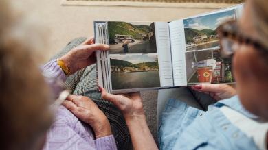 
		Two people looking at a photo album
	