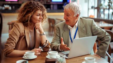 
		Young woman and older man in the office
	