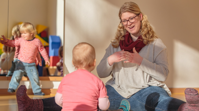 
		Educator with two children in the childcare center
	