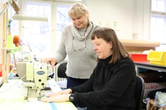
		Women sew wet bags for childcare centers
	