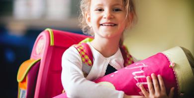 
		A girl holds a school cone
	