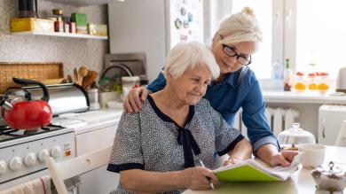 
		Woman takes care of elderly lady
	
