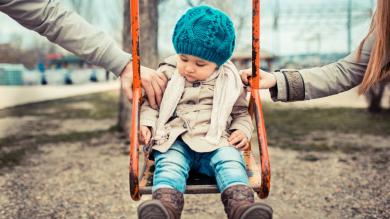 
		Toddler on swing with parents
	