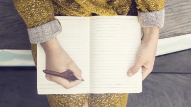 
		A woman takes notes for better time management
	