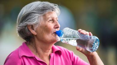 
		Elderly woman drinks water
	