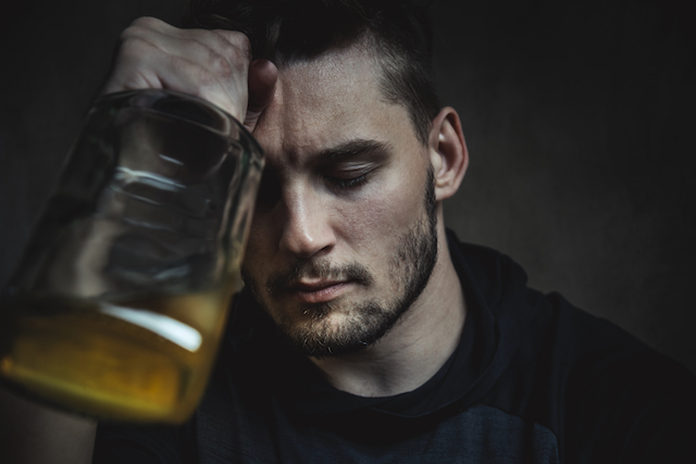 A man with an alcohol addiction is depressed