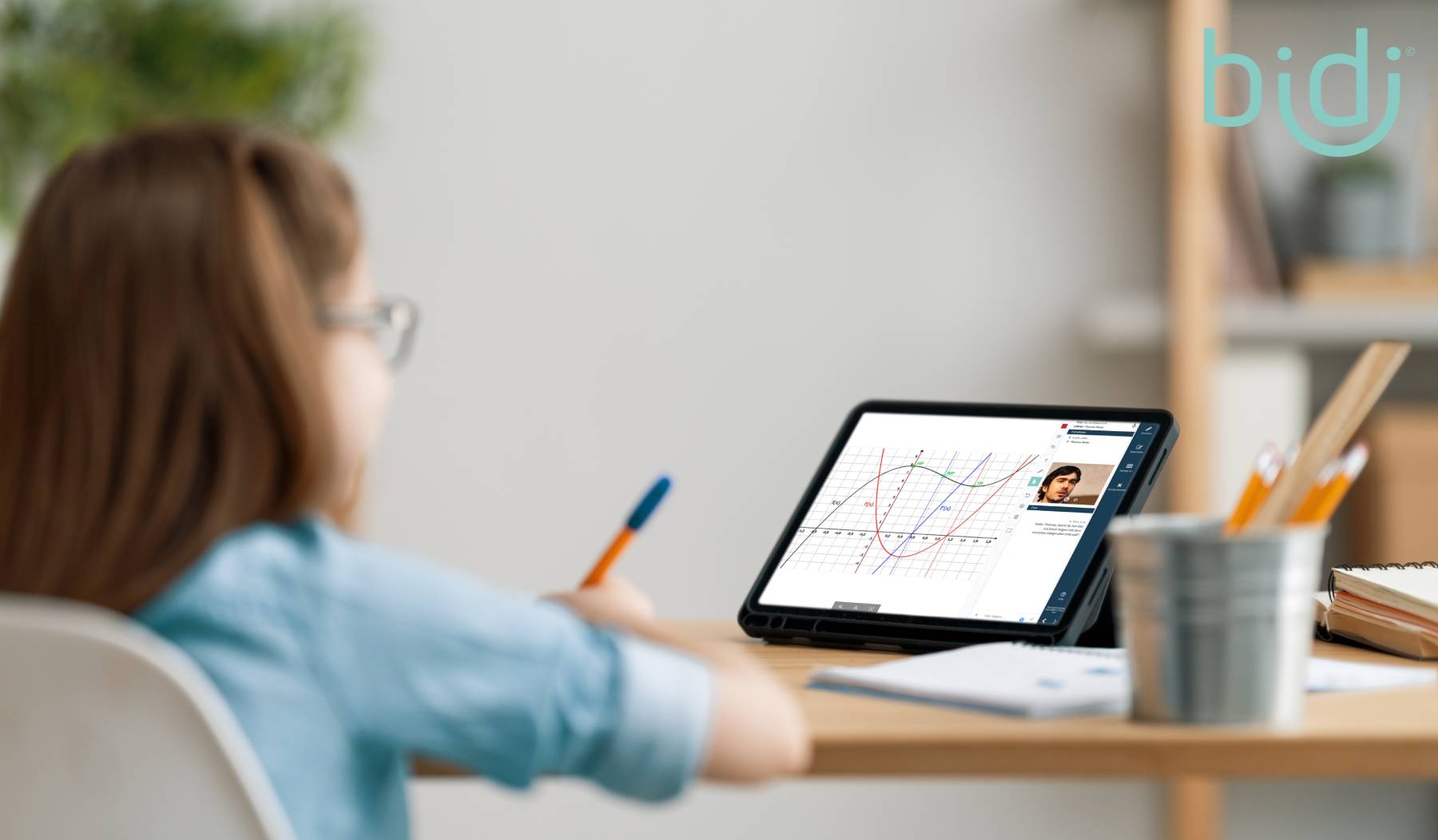 Schoolchild sits in front of an iPad and learns