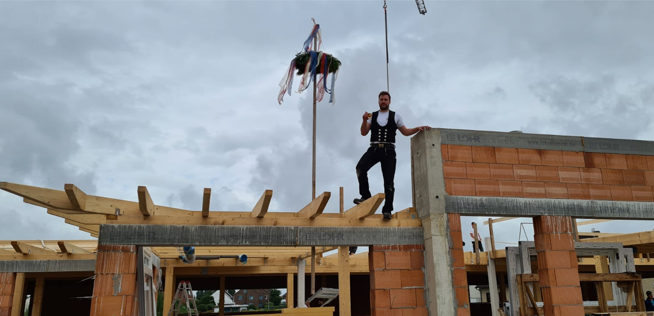 Picture of the building site with a carpenter who is currently working there.