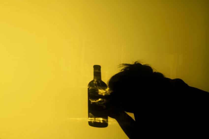 An employee with a bottle of alcohol in his hand