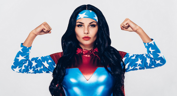 a woman in a superwoman costume and power pose