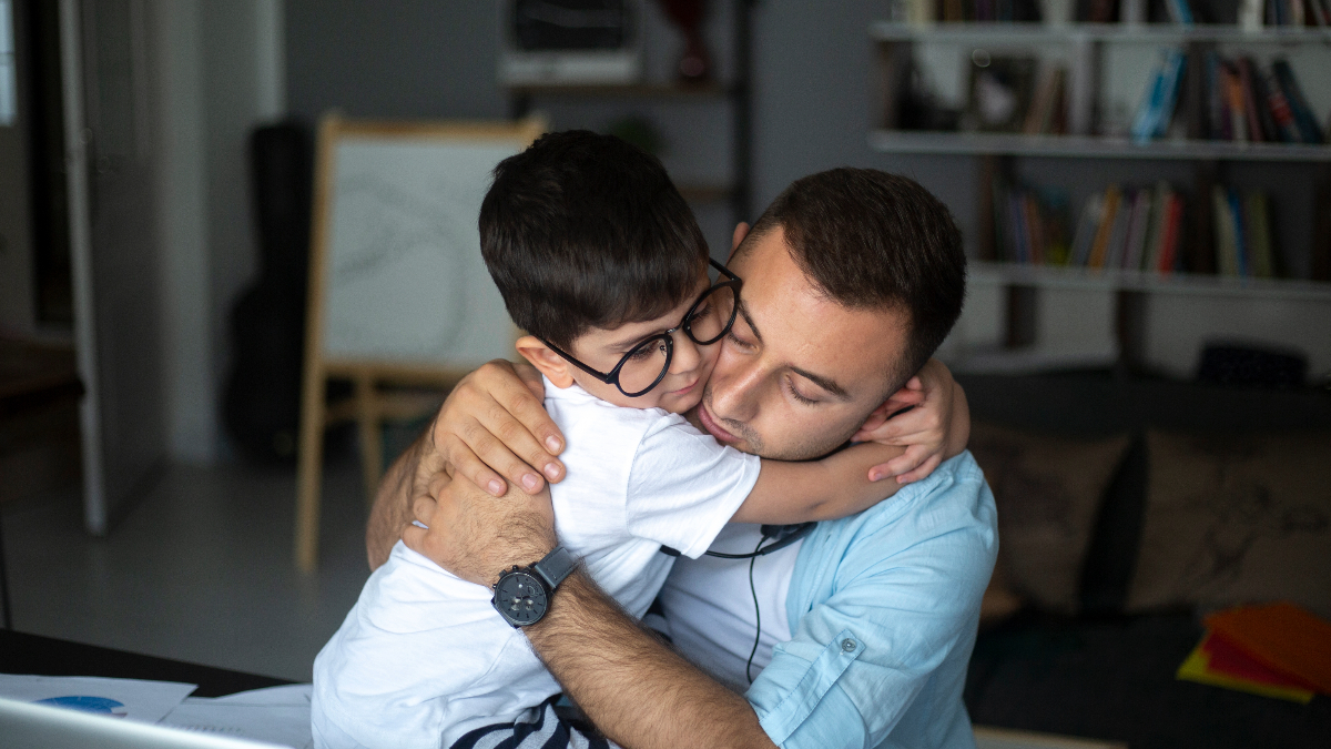 Father and son embrace