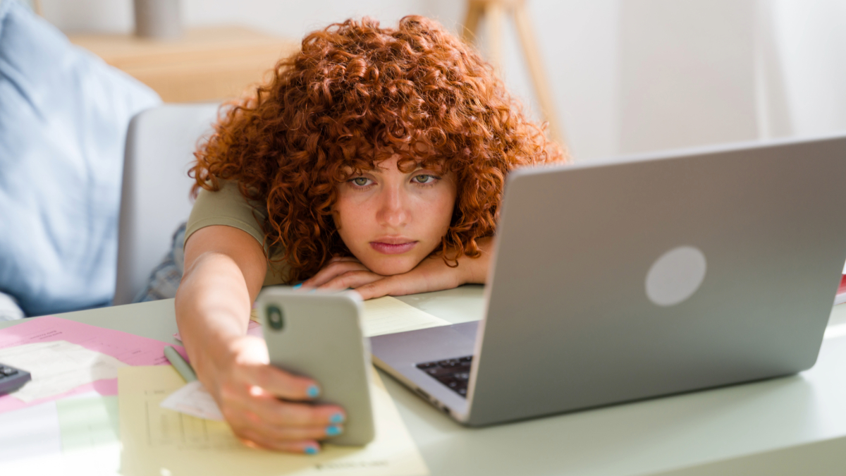 tired young woman in front of laptop