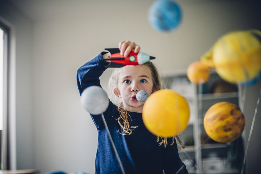 A schoolchild plays astronaut