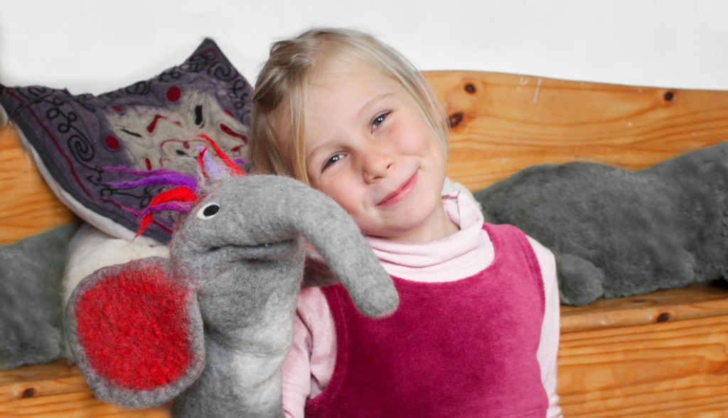 Girl with elephant hand puppet