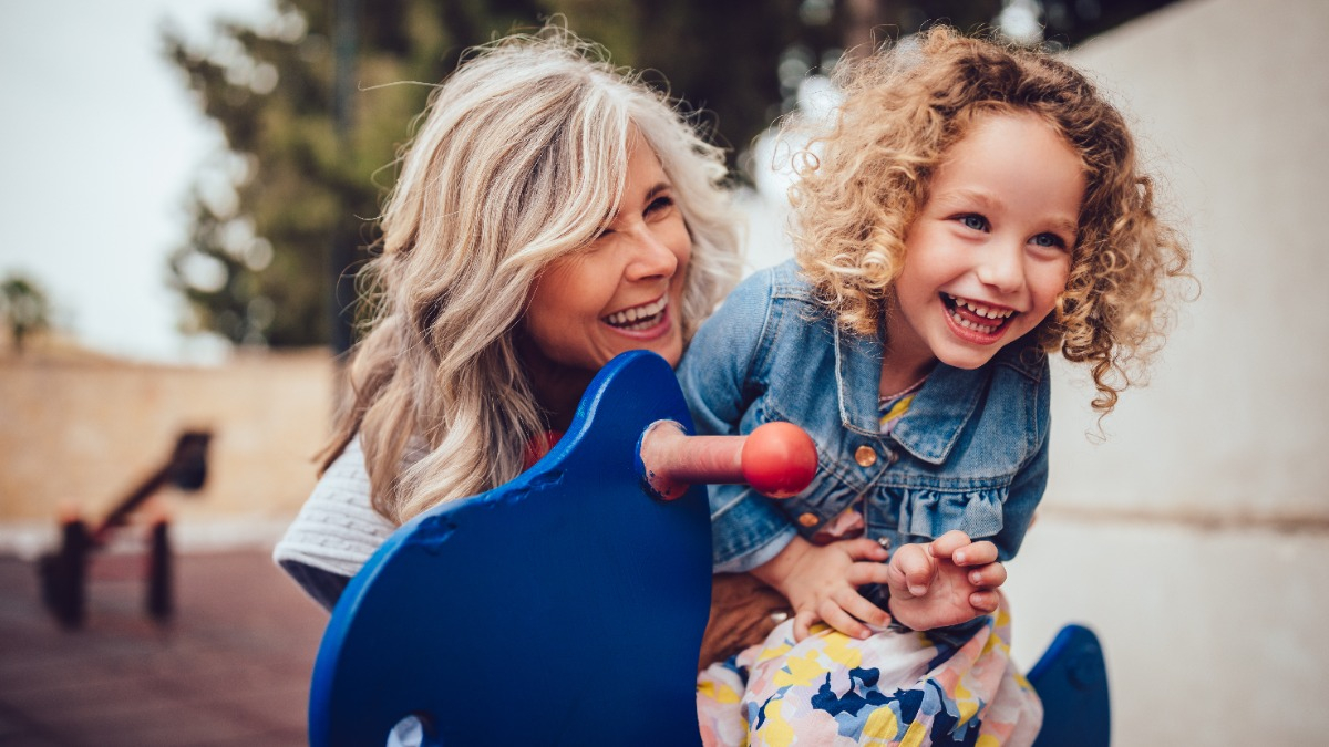 An educator with a child in the playground