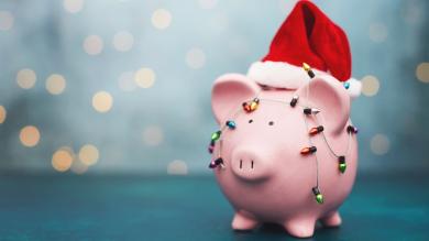 A piggy bank hung with a colorful string of lights