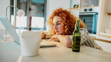 
		Woman sits in front of screen meeting
	