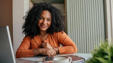 
		Two women look at each other, a laptop in front of them
	