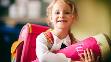 
		A girl holds a school cone
	