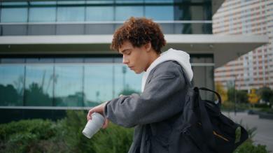 
		a young man looks at his watch
	