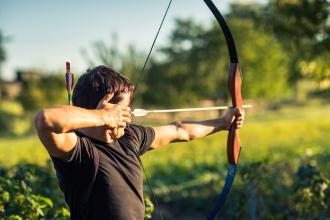 
		A man shoots at a target with a bow
	