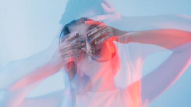 
		A young woman has her hands on her head and is stressed
	