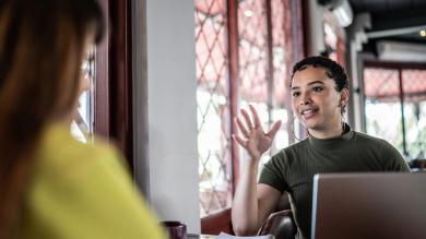 
		A young woman gives feedback to another
	