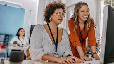 
		two women of different ages working at the desktop
	