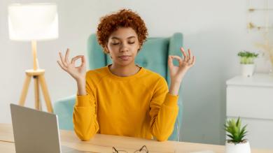 
		Woman at desk doing yoga
	