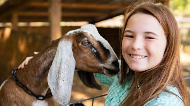 
		Girl with goat smiles
	