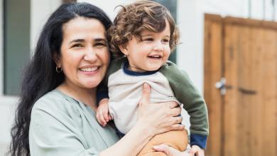 
		A female childminder with a child in her arms
	