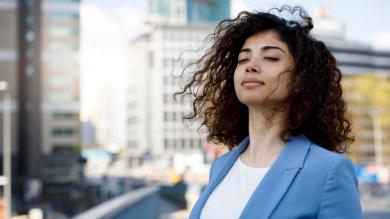 
		A young woman takes a deep breath
	