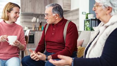 
		An older man is talking to a young volunteer
	