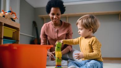 
		Teacher with child playing
	