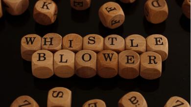 
		Wooden cube with the word whistleblower
	