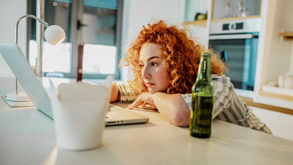 Woman sits in front of screen meeting