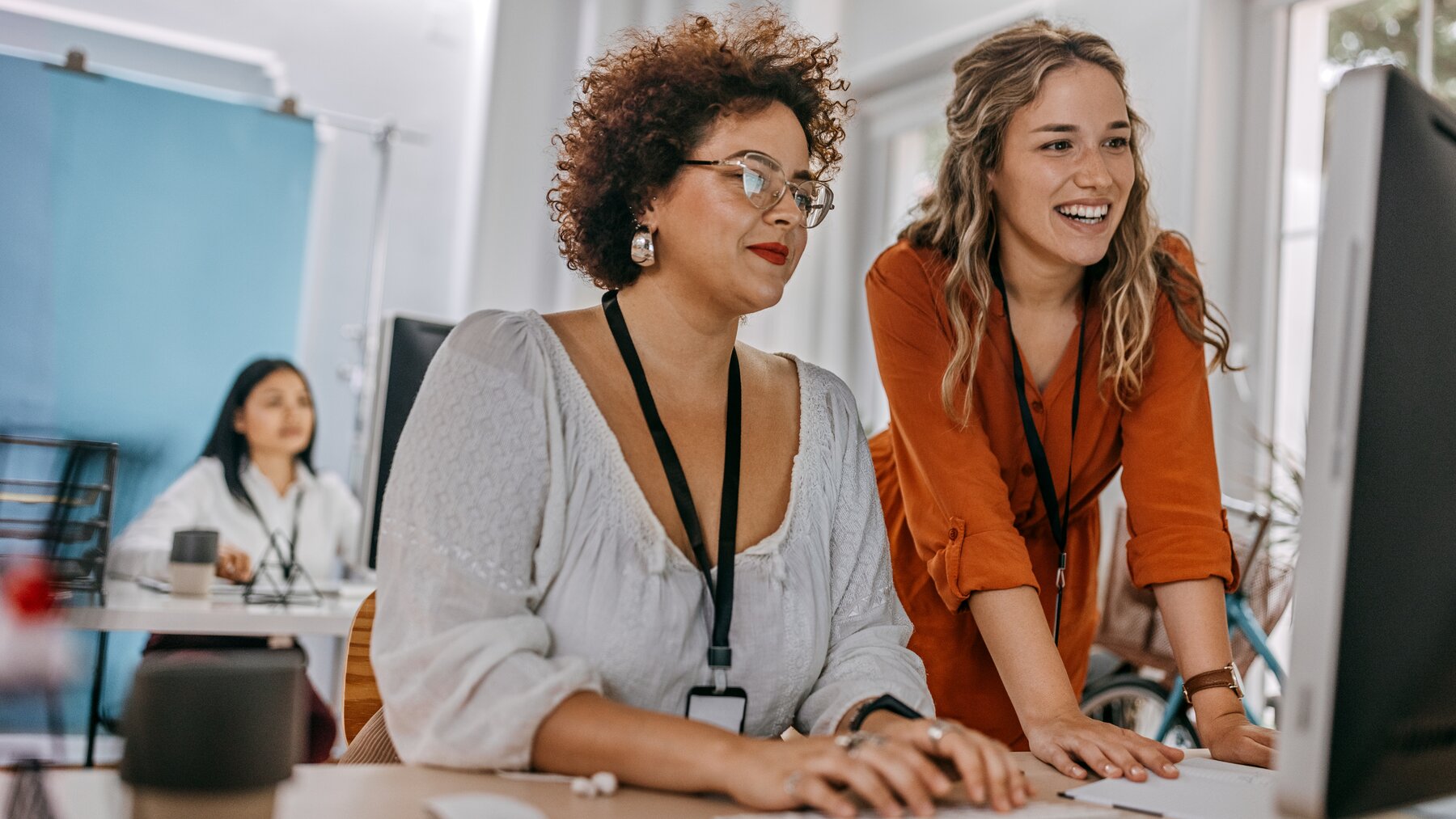 two women of different ages working at the desktop