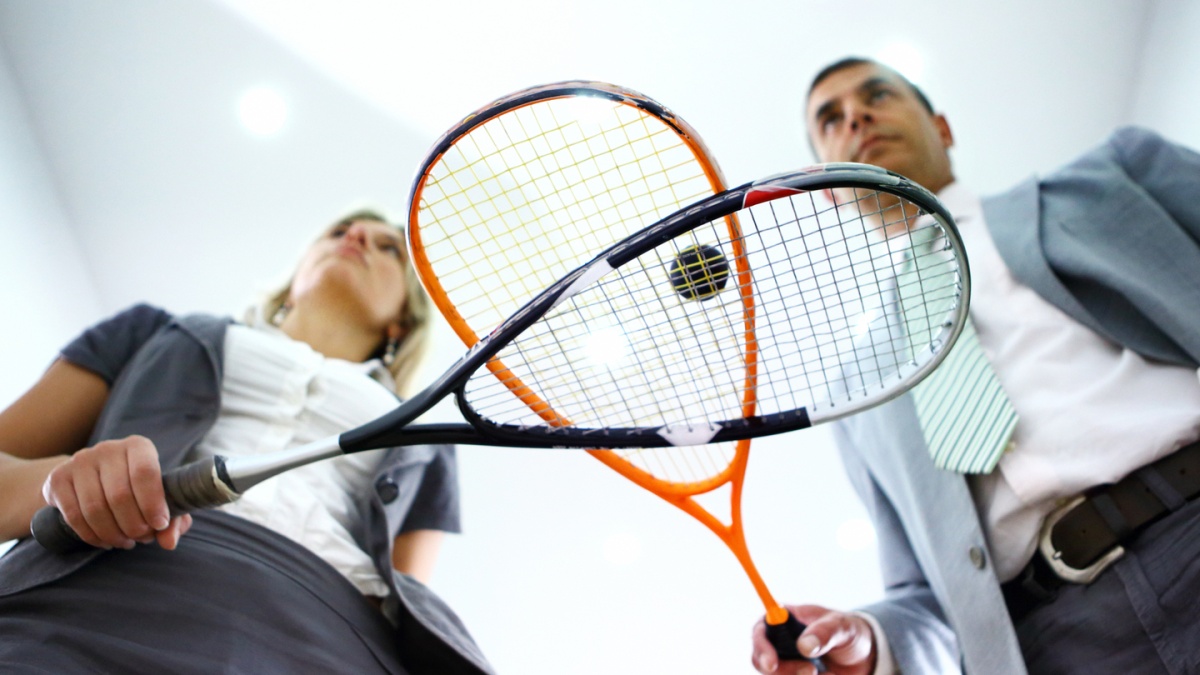 you see people in office outfits playing squash