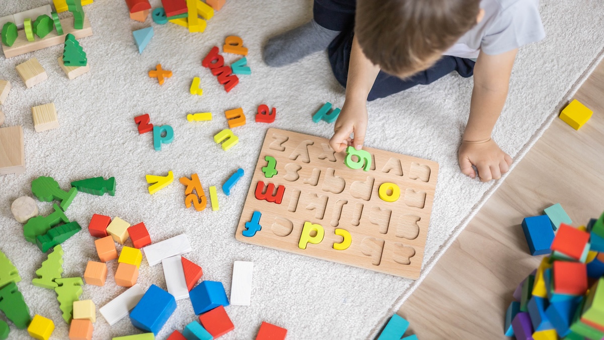 Child plays with colorful letters