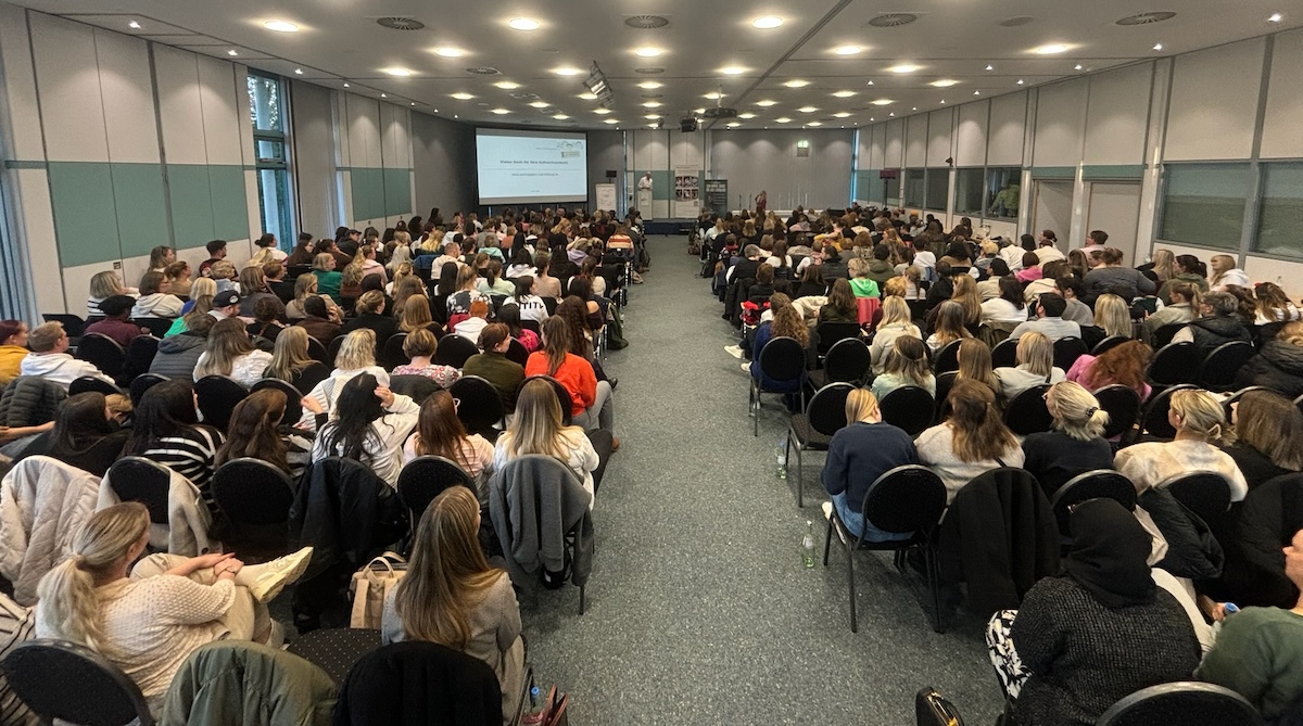 Participants at the Child Protection Day listen to a presentation at the front of the stage