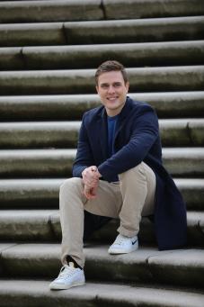 Constantin Schreiber sits on a staircase