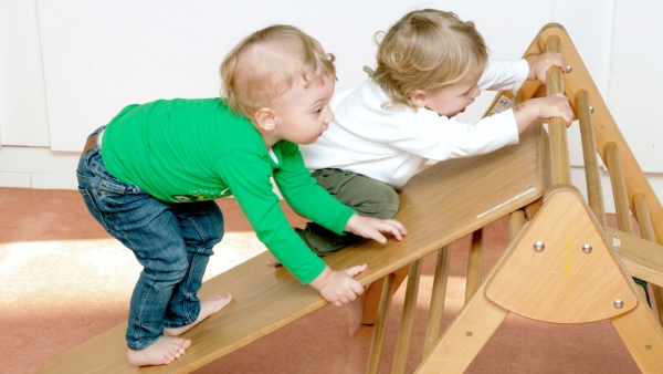 A little boy builds a trunk with wooden building blocks