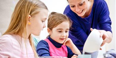 Educator with two children