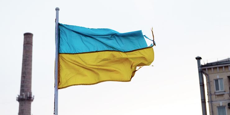 Ukrainian flag fluttering tattered in the wind